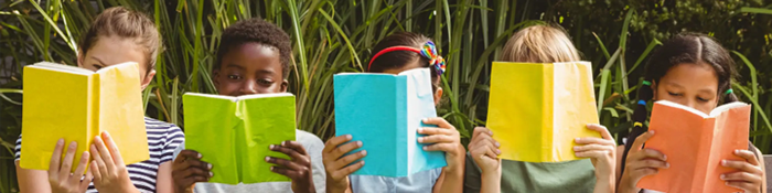 Five children reading books outside.